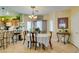 Bright dining area with tiled floors, a chandelier, and lots of natural light at 10450 Kepler Cascades St, Las Vegas, NV 89141