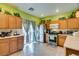 Charming kitchen featuring a stainless refrigerator, plentiful cabinets, and sliding glass doors to the backyard at 10450 Kepler Cascades St, Las Vegas, NV 89141