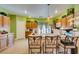 Bright eat-in kitchen with wood cabinets, tile backsplash, granite countertops and stainless steel appliances at 10450 Kepler Cascades St, Las Vegas, NV 89141