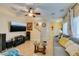 Bright living room with tile floors, a plush sofa, and a staircase to the upper level at 10450 Kepler Cascades St, Las Vegas, NV 89141