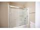Neutral bathroom with a glass enclosed tub-shower and matching toilet at 10643 Petricola St # 103, Las Vegas, NV 89183