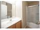 Bathroom features a single sink vanity with a shower and tub combo at 10643 Petricola St # 103, Las Vegas, NV 89183