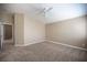 Expansive bedroom with neutral carpet and ceiling fan offers a tranquil retreat with ample space and comfort at 10643 Petricola St # 103, Las Vegas, NV 89183