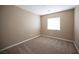 Neutral bedroom with carpet, base trim, and a window at 10643 Petricola St # 103, Las Vegas, NV 89183