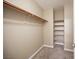 Walk-in closet with rod, upper shelf, and built-in shelving for optimal storage at 10643 Petricola St # 103, Las Vegas, NV 89183