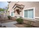 Charming front entrance featuring well-maintained landscaping with decorative rock and bushes around the facade at 10643 Petricola St # 103, Las Vegas, NV 89183