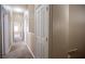 Hallway with neutral carpet and white trim provides flow between rooms at 10643 Petricola St # 103, Las Vegas, NV 89183