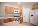 Kitchen with stainless steel appliances, light wood cabinets, and laminate countertops provides a functional space at 10643 Petricola St # 103, Las Vegas, NV 89183