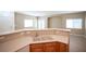 Kitchen bar countertop with sink and laminate countertop that opens to the living room with natural light at 10643 Petricola St # 103, Las Vegas, NV 89183