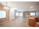 Spacious living area with a partial view of the kitchen, great natural light, and tile flooring at 10643 Petricola St # 103, Las Vegas, NV 89183