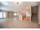 Open-concept living area with tile flooring, seamlessly connecting the living space with the modern kitchen at 10643 Petricola St # 103, Las Vegas, NV 89183
