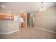 Open-concept living room and kitchen with tile flooring and neutral color palette exudes warmth and sophistication at 10643 Petricola St # 103, Las Vegas, NV 89183