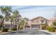 Street view of neighborhood homes with private gates and well-manicured landscaping at 10643 Petricola St # 103, Las Vegas, NV 89183
