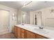 Bathroom with a double vanity, large mirror, and adjacent toilet room at 10730 Amber Ridge Dr # 205, Las Vegas, NV 89144