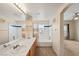 Bathroom featuring double sinks, large mirror, and a bathtub/shower combination at 10730 Amber Ridge Dr # 205, Las Vegas, NV 89144