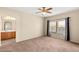 Spacious primary bedroom with large windows, neutral carpet, and an en-suite bathroom at 10730 Amber Ridge Dr # 205, Las Vegas, NV 89144