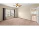 Bedroom featuring neutral walls, carpet, a ceiling fan and large windows at 10730 Amber Ridge Dr # 205, Las Vegas, NV 89144