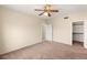 Spacious bedroom with a ceiling fan and neutral carpet and a walk-in closet at 10730 Amber Ridge Dr # 205, Las Vegas, NV 89144