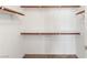 Walk-in closet with wood shelving and neutral carpet at 10730 Amber Ridge Dr # 205, Las Vegas, NV 89144