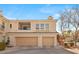 Stylish townhome featuring a two-car garage and an inviting facade, blending comfort with desert charm at 10730 Amber Ridge Dr # 205, Las Vegas, NV 89144