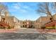 Inviting condo complex with stucco facade, red accents, garages, and well-kept landscaping at 10730 Amber Ridge Dr # 205, Las Vegas, NV 89144
