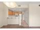 Bright kitchen featuring oak cabinets, white appliances, and a breakfast bar overlooking the dining area at 10730 Amber Ridge Dr # 205, Las Vegas, NV 89144
