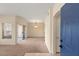 Open-concept living room with neutral carpet, sliding door to balcony, and modern lighting at 10730 Amber Ridge Dr # 205, Las Vegas, NV 89144