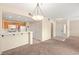 Living area featuring neutral carpet, and open access to the kitchen with breakfast bar at 10730 Amber Ridge Dr # 205, Las Vegas, NV 89144