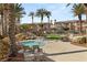 Beautiful community pool and spa area offering lush landscaping and comfortable seating for relaxation at 10730 Amber Ridge Dr # 205, Las Vegas, NV 89144