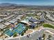 High angle view featuring community center pool and tennis courts with distant mountain views and clear skies at 11185 Black Fire Opal Dr, Las Vegas, NV 89138