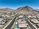 Expansive aerial perspective showcasing a neighborhood with stunning mountain scenery and orderly street layout at 11185 Black Fire Opal Dr, Las Vegas, NV 89138