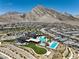 Panoramic image of neighborhood with lush community pool and modern amenities against majestic mountain backdrop at 11185 Black Fire Opal Dr, Las Vegas, NV 89138