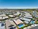Elevated shot of a neighborhood displaying homes with pools and lush landscapes, framed by distant mountains at 11185 Black Fire Opal Dr, Las Vegas, NV 89138