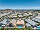 Bird's eye view of a community with homes featuring pools and manicured landscaping, set against distant city skyline at 11185 Black Fire Opal Dr, Las Vegas, NV 89138