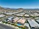 Wide-angle shot of a housing development featuring private pools and scenic mountain vistas at 11185 Black Fire Opal Dr, Las Vegas, NV 89138