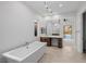 Bright bathroom features a freestanding tub and backyard pool views at 11185 Black Fire Opal Dr, Las Vegas, NV 89138