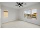 A carpeted bedroom boasts abundant natural light from windows showcasing exterior views at 11185 Black Fire Opal Dr, Las Vegas, NV 89138
