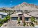 Modern home with brick driveway, xeriscaping, mountain views at 11185 Black Fire Opal Dr, Las Vegas, NV 89138