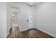 Bright foyer with modern lighting, wood-look flooring, and a sleek front door with glass inserts at 11185 Black Fire Opal Dr, Las Vegas, NV 89138