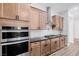 A modern kitchen boasts stainless steel appliances, granite countertops, and custom cabinets at 11185 Black Fire Opal Dr, Las Vegas, NV 89138