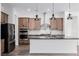 Modern kitchen featuring stainless steel appliances, dark granite countertops, and wood cabinetry at 11185 Black Fire Opal Dr, Las Vegas, NV 89138
