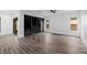 Open living room with modern finishes, wood-look flooring, and a sliding glass door to the outdoors at 11185 Black Fire Opal Dr, Las Vegas, NV 89138