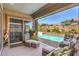 Comfortable covered patio featuring stylish furniture and serene views of the sparkling pool at 11185 Black Fire Opal Dr, Las Vegas, NV 89138