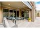 The covered patio has a glass table and modern furniture with great views at 11185 Black Fire Opal Dr, Las Vegas, NV 89138