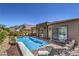 A beautiful pool surrounded by a brick patio and a view of the neighborhood at 11185 Black Fire Opal Dr, Las Vegas, NV 89138