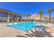 Resort-style pool with lounge chairs, set against a backdrop of mountains and palm trees for luxurious relaxation at 11185 Black Fire Opal Dr, Las Vegas, NV 89138