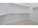 A bright walk-in closet featuring shelving for ample storage and plush carpeting at 11185 Black Fire Opal Dr, Las Vegas, NV 89138