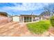 Large backyard features a brick wall, a screened in patio, and grass at 1120 Mariposa Way, Boulder City, NV 89005