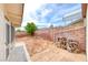 Home's backyard features a brick wall, a screened in patio, and a tree at 1120 Mariposa Way, Boulder City, NV 89005