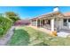 Lush backyard with covered patio, screened-in porch, and mature landscaping at 1120 Mariposa Way, Boulder City, NV 89005